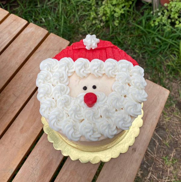 Mini torta navideña decorada con la cara de Santa Claus en buttercream